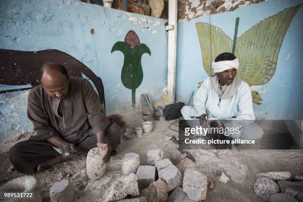 Photo made available on 26 December 2017, shows craftsmen carving Alabaster pots at a local factory, in Gurna village, Luxor, Upper Egypt, 09...