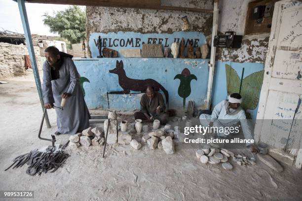 Photo made available on 26 December 2017, shows craftsmen carving Alabaster pots at a local factory, in Gurna village, Luxor, Upper Egypt, 09...