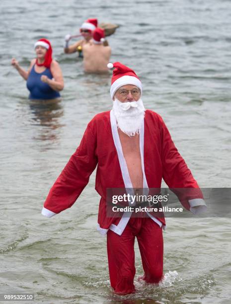 Man dressed as Santa takes part in the "Berliner Seehunde" club's Christmas swim at Orankesee lake in Berlin, Germany, 25 December 2017. Photo: Paul...