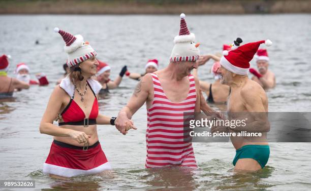 Dpatop - People taking part in the "Berliner Seehunde" club's Christmas swim at Orankesee lake in Berlin, Germany, 25 December 2017. Photo: Paul...