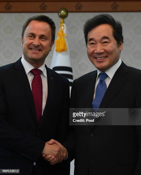 Luxembourg's Prime Minister Xavier Bettel shakes hands with South Korean Prime Minister Lee Nak-yeon during their meeting on July 2, 2018 in Seoul,...
