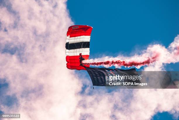 Member of the Red Devils display team during a skydive into the event with a banner attached to his foot reading "ARMY - BE THE BEST". Stirling shows...