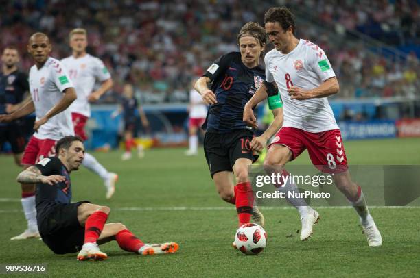 Sime Vrsaljko and Luka Modric of Croatia vies Thomas Delaney of Denmark during the 2018 FIFA World Cup Russia Round of 16 match between Croatia and...