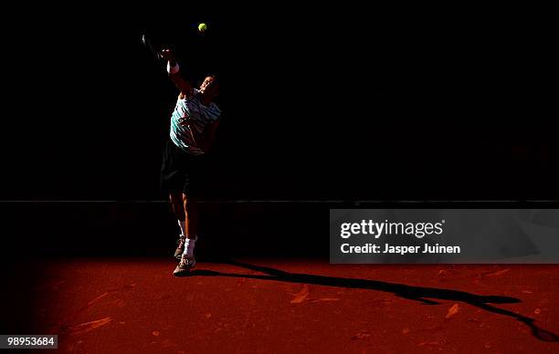 Lukasz Kubot of Poland smashes the ball to Feliciano Lopez of Spain in their first round match during the Mutua Madrilena Madrid Open tennis...