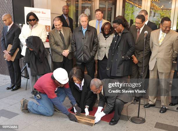 Jonelle Procope , President and CEO of the Apollo Theater and Billy Mitchell , Apollo Historian install the first plaque, the one of late James Brown...