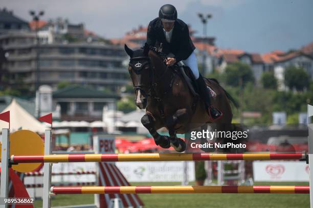 One of the riders jumps a double obstacle during participation in the international Santander jumping contest in Santander, Spain, on 1st July 2018.
