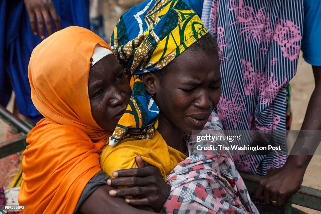 Gwoza, Nigeria- A woman suffering from severe malaria writhes i