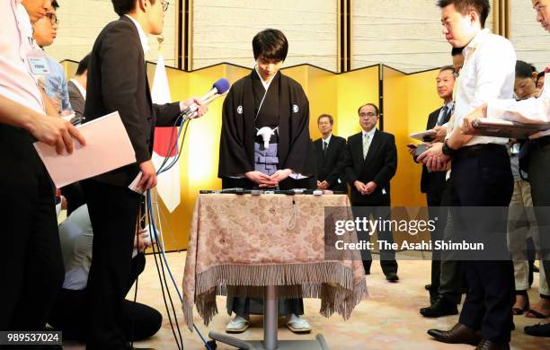 Two-time Olympic figure skating Men's Singles gold medalist Yuzuru Hanyu responds questions from reporters after the People's Honour Award ceremony...