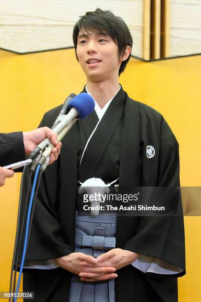 Two-time Olympic figure skating Men's Singles gold medalist Yuzuru Hanyu responds questions from reporters after the People's Honour Award ceremony...