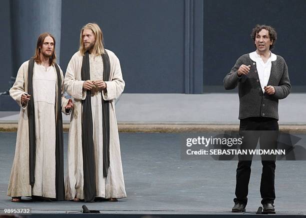 German theatre director Christian Stueckl and Frederick Mayet and Andreas Richter who both play Jesus stand on stage before dress rehearsals at...