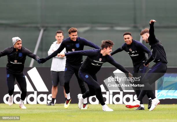 Harry Maguire of England attempts to tag Gary Cahill of England as Kyle Walker of England, Dele Alli of England and Trent Alexander-Arnold of England...