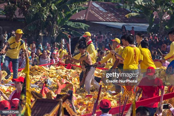 People participate in Bakar Tongkang Festival or the barge burning tradition in Bagansiapi-Api, Riau, Indonesia, on June 30, 2018. A paper barge is...