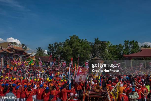 People participate in Bakar Tongkang Festival or the barge burning tradition in Bagansiapi-Api, Riau, Indonesia, on June 30, 2018. A paper barge is...