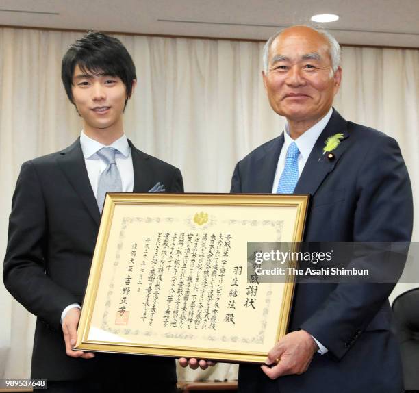 Two-time Olympic figure skating Men's Singles gold medalist Yuzuru Hanyu receives certificate of appreciation from the Reconstriction Minister...