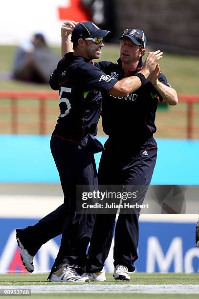 Paul Collingwood of England congratulates Michael Lumb for the catch which dismissed Brendon McCullum during the ICC World Twenty20 Super Eight match...