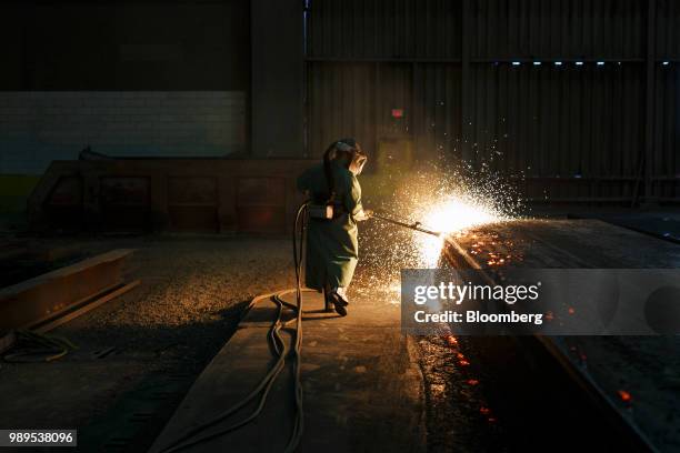 Sparks fly as an employee performs a quality check on a steel slab at the Stelco Holdings Inc. Plant in Nanticoke, Ontario, Canada, on Tuesday, Nov....