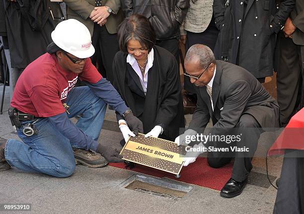 Jonelle Procope , President and CEO of the Apollo Theater and Billy Mitchell , Apollo Historian install the first plaque, the one of late James Brown...