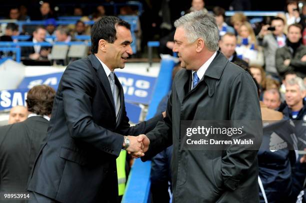 Roberto Martinez the Wigan manager shakes hands with Carlo Ancelotti the Chelsea manager prior to kickoff during the Barclays Premier League match...