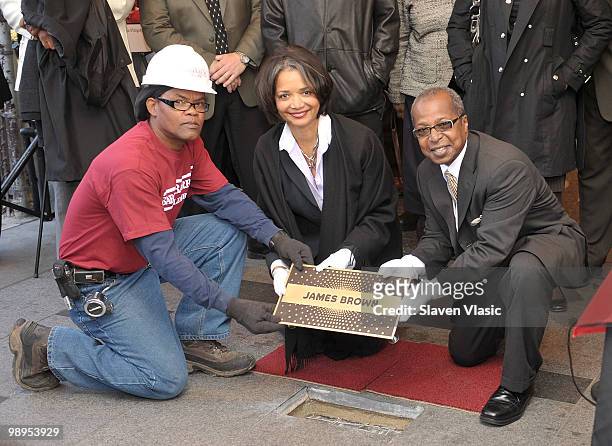 Jonelle Procope , President and CEO of the Apollo Theater and Billy Mitchell , Apollo Historian install the first plaque, the one of late James Brown...