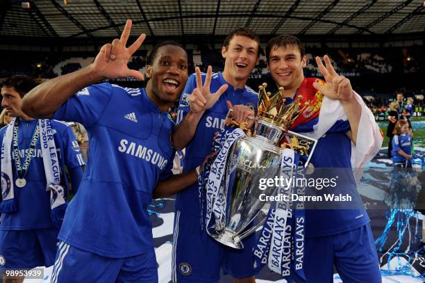 Chelsea's Didier Drogba, Nemanja Matic and Branislav Ivanovic celebrate with the trophy after winning the league with an 8-0 victory during the...