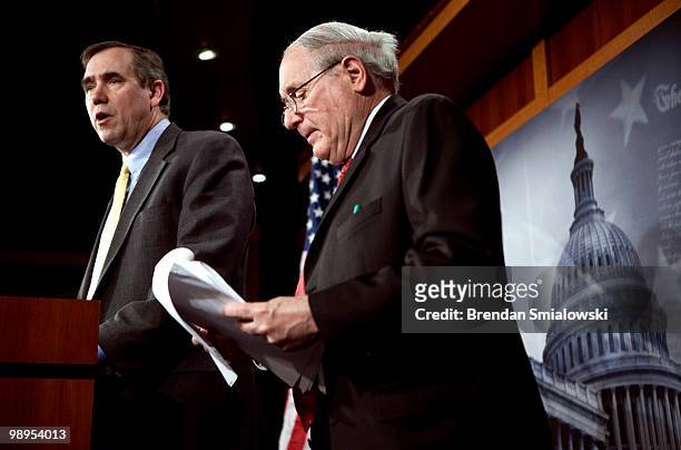 Sen. Carl Levin looks over papers while Sen. Jeff Merkley speaks during a press conference on Capitol Hill May 10, 2010 in Washington, DC. Levin and...