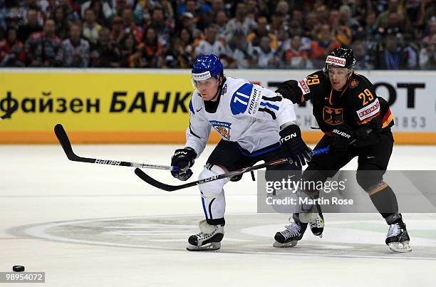 Alexander Barta of Germany and Leo Komarov of Finland battle for the puck during the IIHF World Championship group A match between Germany and...