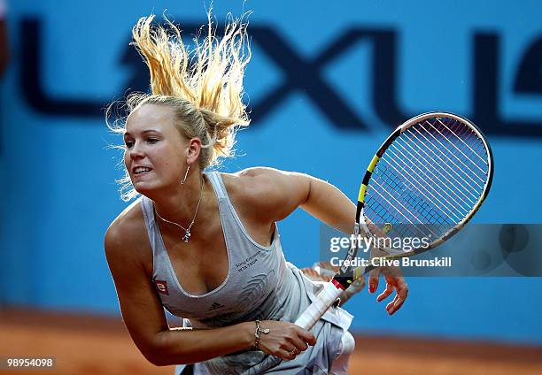 Caroline Wozniacki of Denmark serves against Petra Kvitova of Czech Republic in their first round match during the Mutua Madrilena Madrid Open tennis...