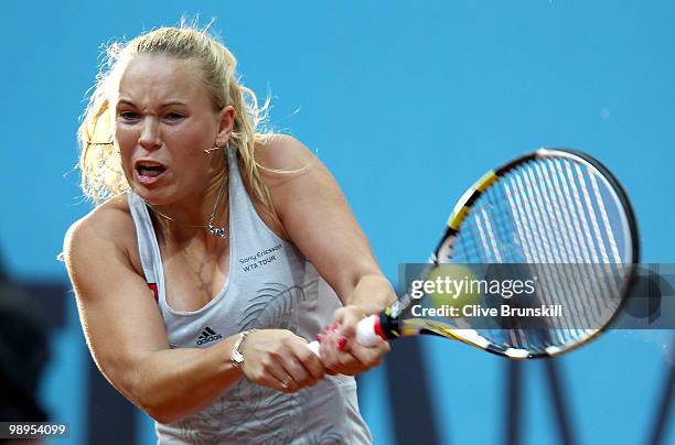 Caroline Wozniacki of Denmark plays a backhand against Petra Kvitova of Czech Republic in their first round match during the Mutua Madrilena Madrid...