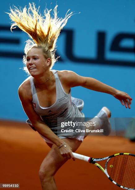 Caroline Wozniacki of Denmark serves against Petra Kvitova of Czech Republic in their first round match during the Mutua Madrilena Madrid Open tennis...