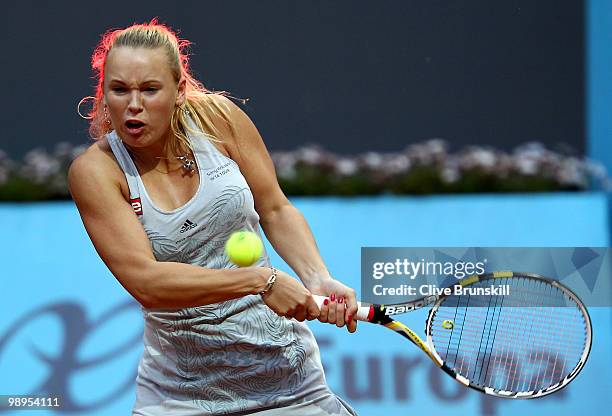 Caroline Wozniacki of Denmark plays a backhand against Petra Kvitova of Czech Republic in their first round match during the Mutua Madrilena Madrid...
