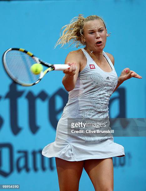 Caroline Wozniacki of Denmark plays a forehand against Petra Kvitova of Czech Republic in their first round match during the Mutua Madrilena Madrid...