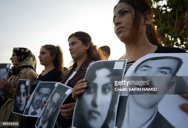 Iranian Kurds hold up pictures of Five Kurdish rebels, including two women, who were killed last week after they battled Iran's elite Revolutionary...