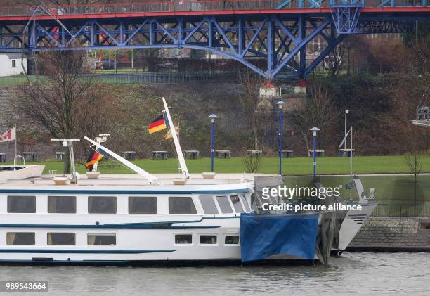 The damaged ship is tied to another ship at the dock in Duisburg, Germany, 27 December 2017. Photo: Roland Weihrauch/dpa