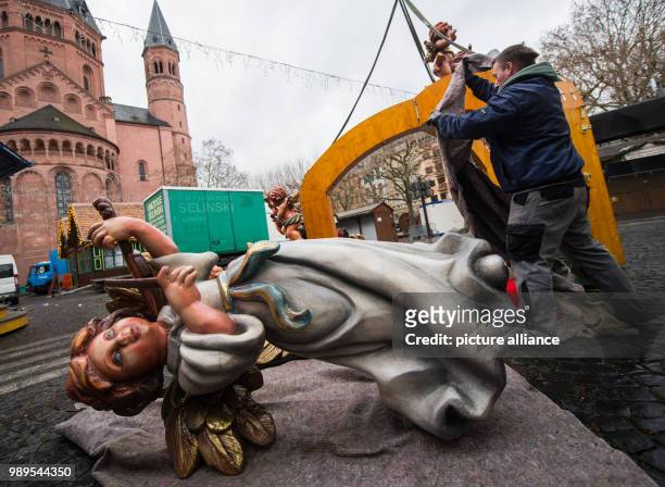 Dismantled angel lies on the ground in Mainz, Germany, 27 December 2017. The angels are the rooftop decoration of a Christmas market stand in Mainz....