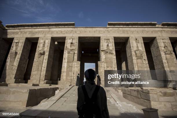 Picture provided on 28 December 2017 shows a tourist visiting the Mortuary Temple of Ramesses III at Medinet Habu , in Luxor, Upper Egypt, 10...