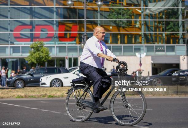 German Economy Minister and Christian Democratic Union politician Peter Altmaier leaves on his bicycle after a party leadership meeting at the CDU...