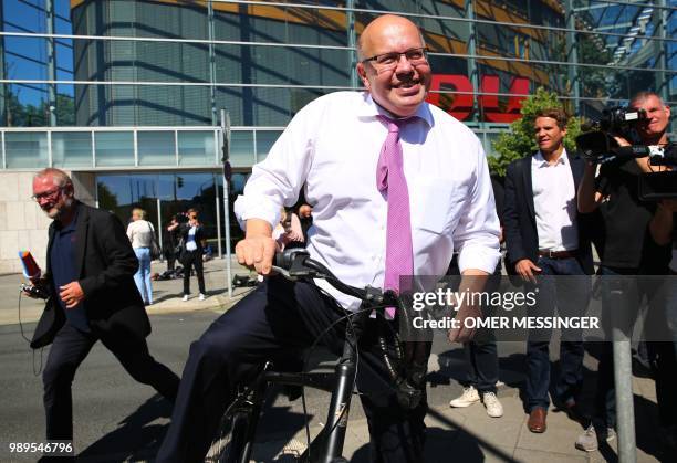 German Economy Minister and Christian Democratic Union politician Peter Altmaier leaves on his bicycle after a party leadership meeting at the CDU...