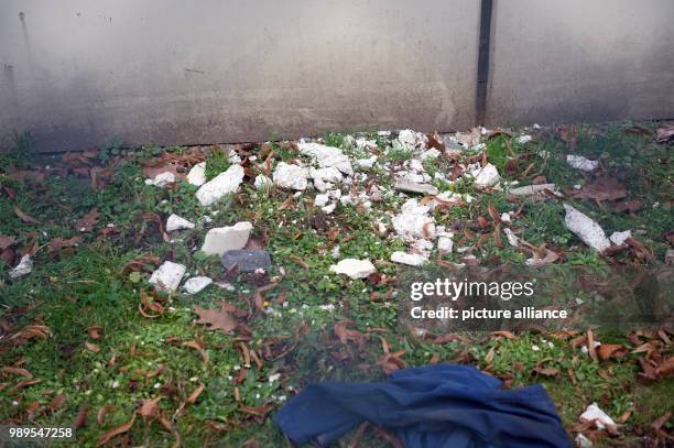 Debris of a broken ventilation slot lie on the ground in front of the workshop building on the ground of the Ploetzensee prison in Berlin, Germany,...