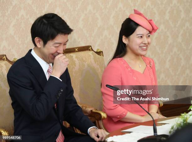Princess Ayako of Takamado and her fiance Kei Moriya shake a laugh during a press conference on their engagement at the Imperial Household Agency on...