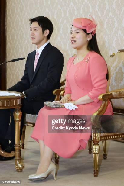Princess Ayako, the youngest daughter of Emperor Akihito's late cousin Prince Takamado, and Kei Moriya attend a press conference at the Imperial...
