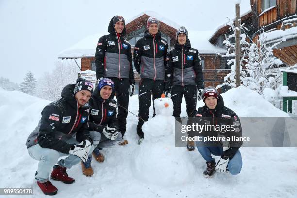 The Austrian ski jumpers Manuel Fettner , Stefan Kraft, Gregor Schlierenzauer, Daniel Huber, Clemens Aigner and Michael Hayboeck pose with a snowman...