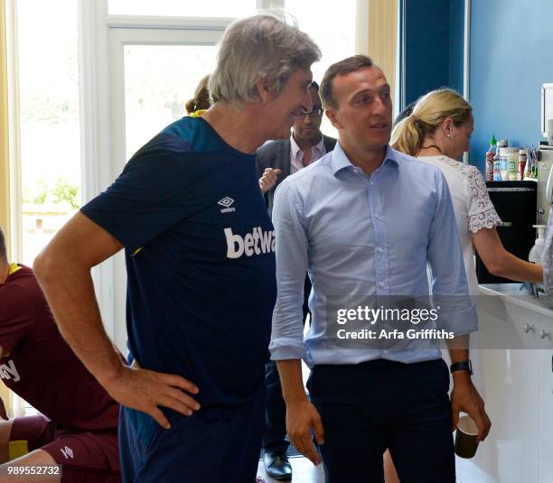 Manuel Pellegrini and Mark Noble of West Ham United return for Pre-Season Training at Rush Green on July 2, 2018 in Romford, England.