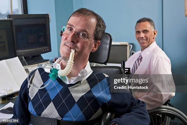 businessman with duchenne muscular dystrophy using a breathing ventilator and his colleague with spinal cord injury behind him - duchenne muscular dystrophy bildbanksfoton och bilder