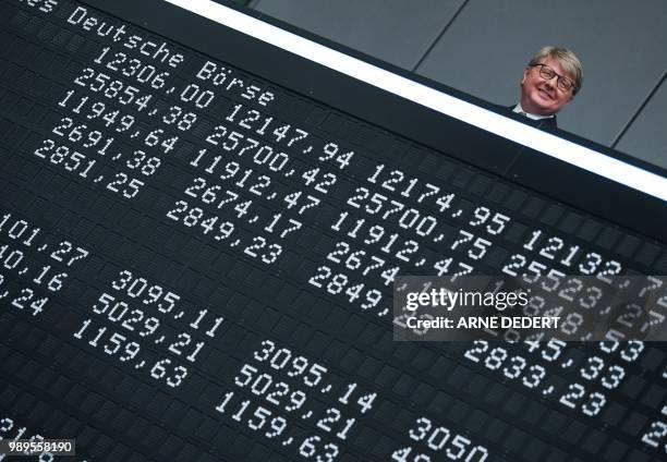 Theodor Weimer, chairman of the Deutsche Boerse AG stocks operator, stands behind a board displaying stock marked indices during festivities to...