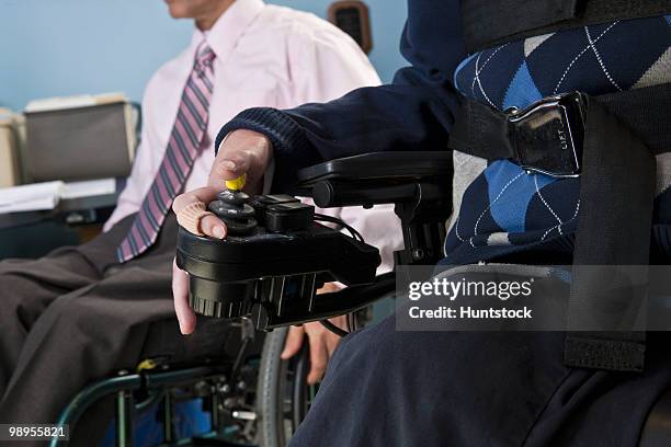 businessman with duchenne muscular dystrophy using a motorized wheelchair beside his colleague with spinal cord injury - duchenne muscular dystrophy bildbanksfoton och bilder