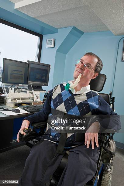 businessman with duchenne muscular dystrophy using a breathing ventilator in an office - duchenne muscular dystrophy bildbanksfoton och bilder