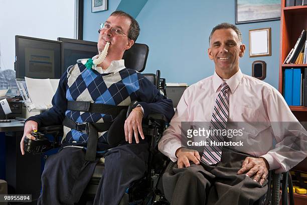 two businessmen in an office, one with muscular dystrophy and breathing ventilator and another with spinal cord injury - duchenne muscular dystrophy bildbanksfoton och bilder