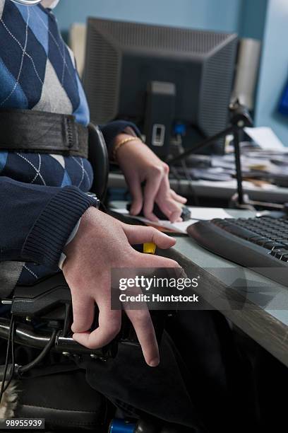 businessman with duchenne muscular dystrophy in a motorized wheelchair working in an office - duchenne muscular dystrophy bildbanksfoton och bilder