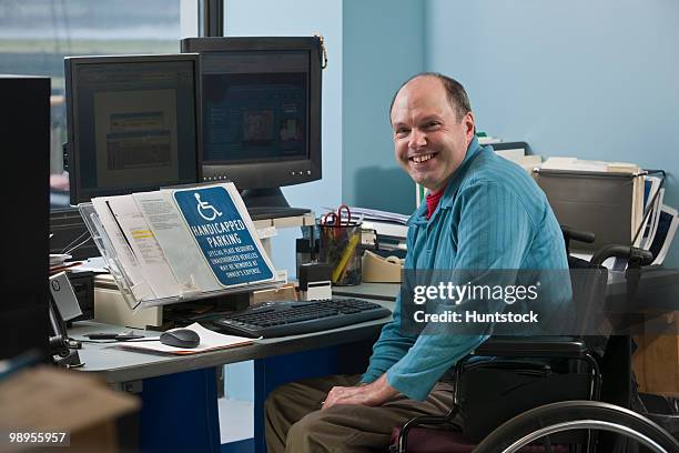 businessman in a wheelchair in an office - handicap parking space stock pictures, royalty-free photos & images