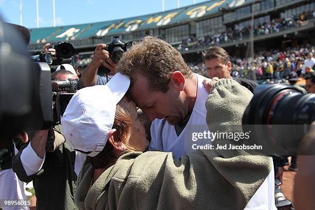 Dallas Braden of the Oakland Athletics celebrates after pitching a perfect game against the Tampa Bay Rays with his grandmother Peggy Lindsey during...